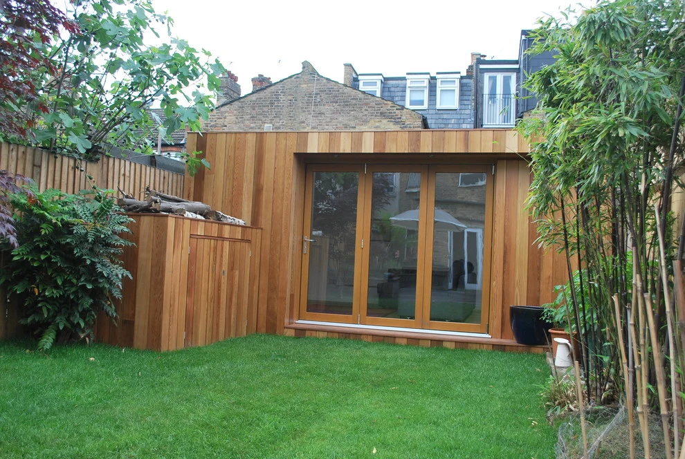 Rebuilt garden shed with tidy lawn in a London garden project