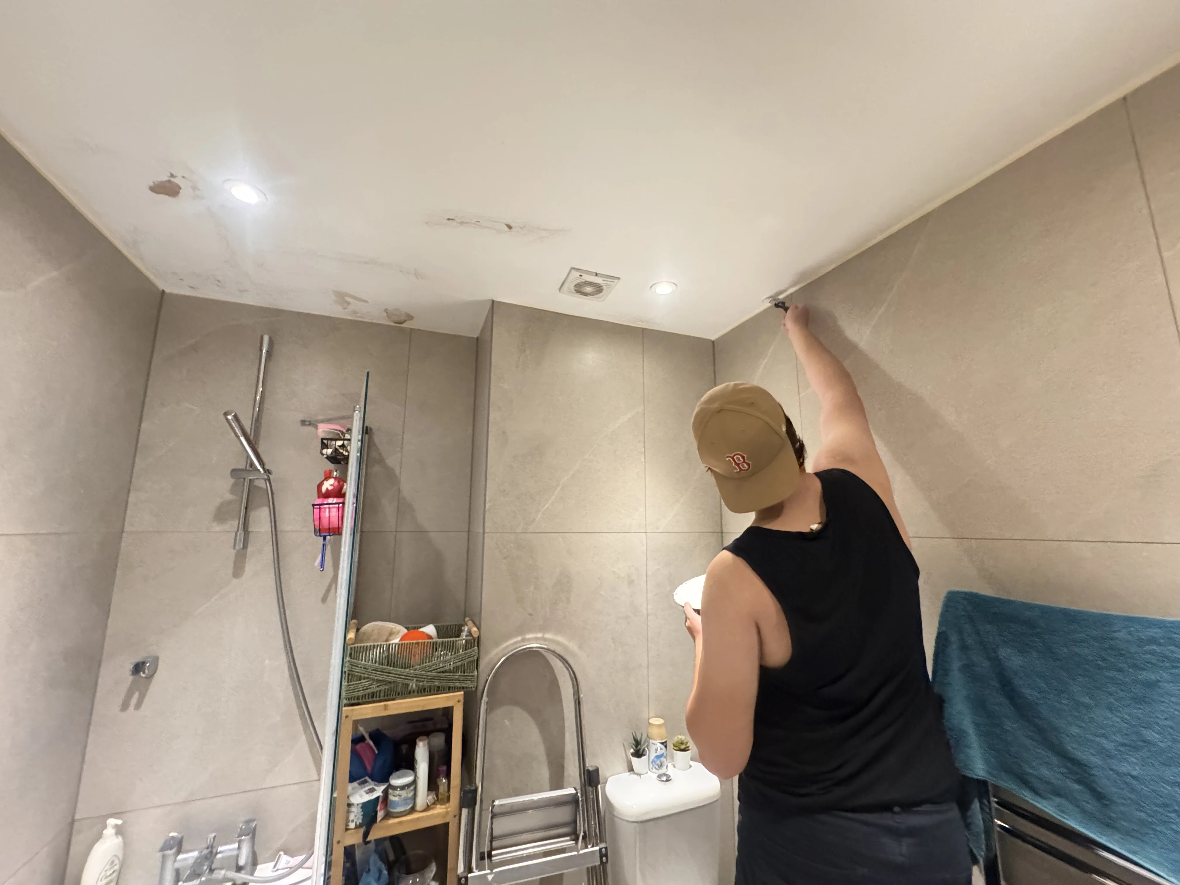 Community Heroes volunteer carrying out ceiling repairs