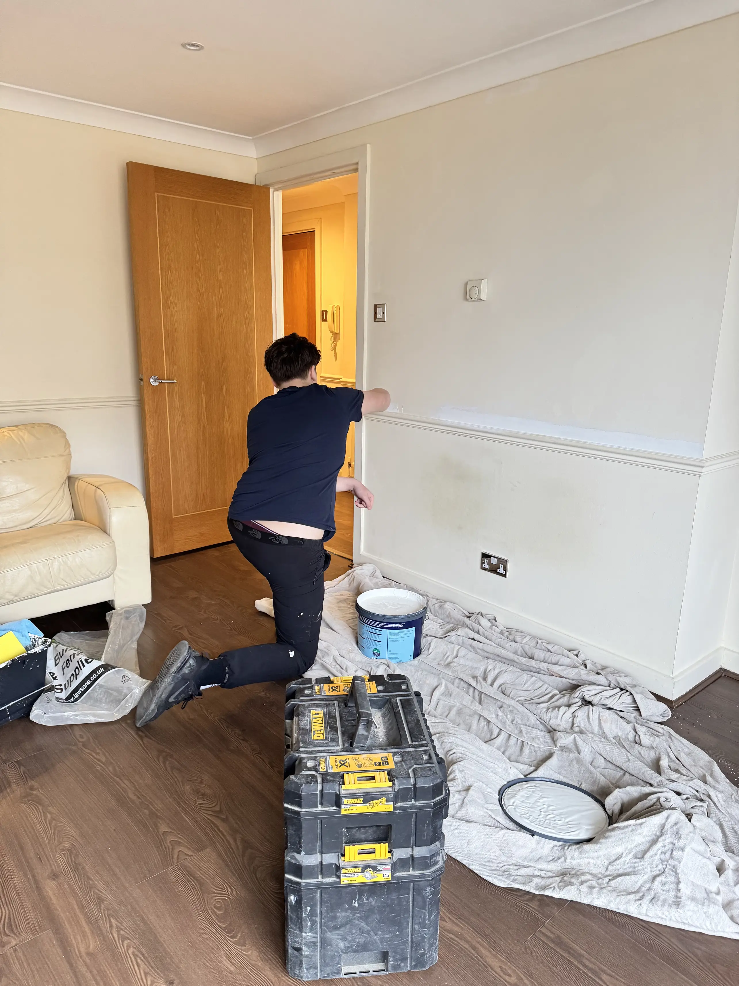 Community Heroes volunteer painting inside a home