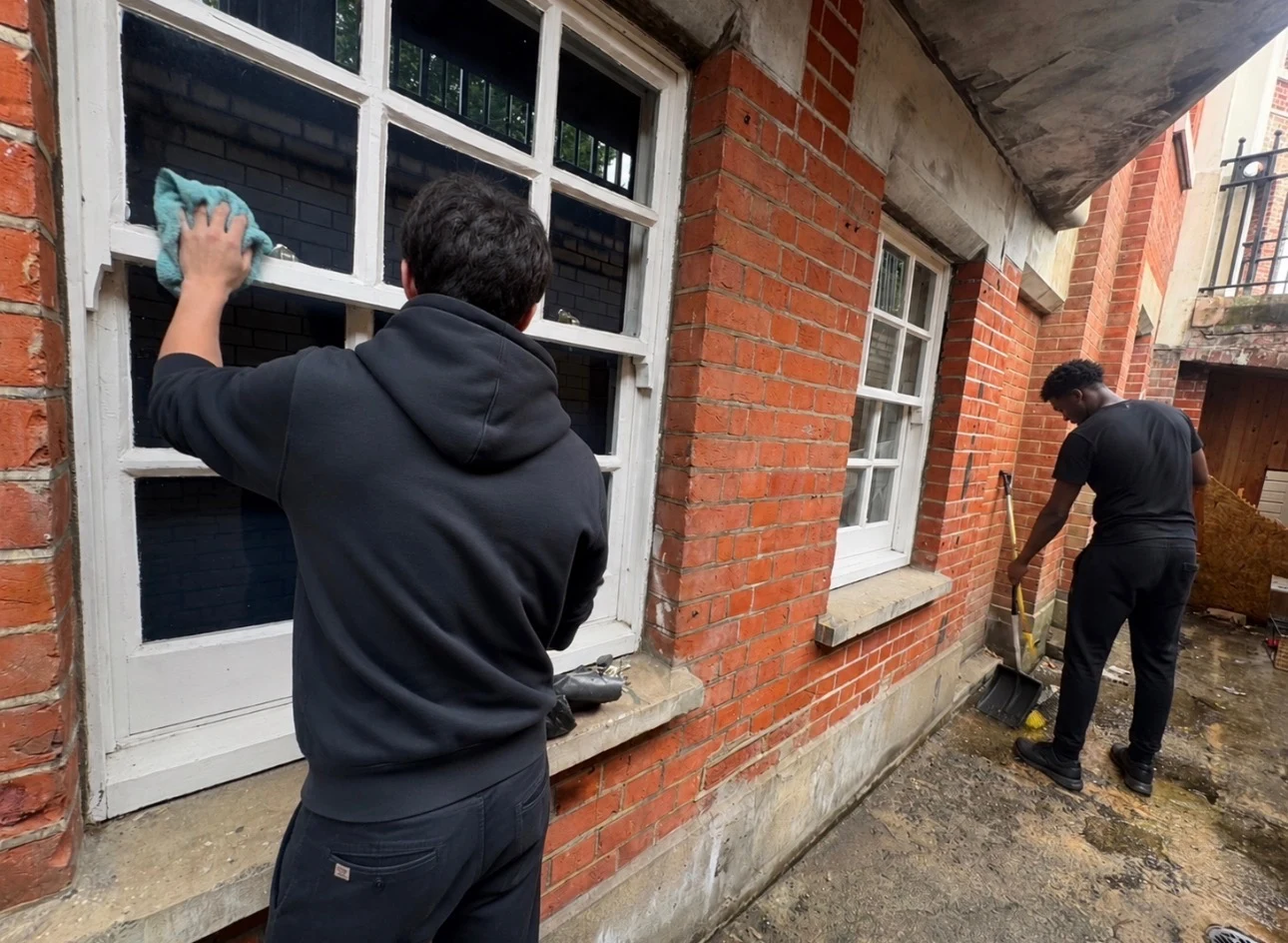 Community Heroes volunteers working together on a building exterior